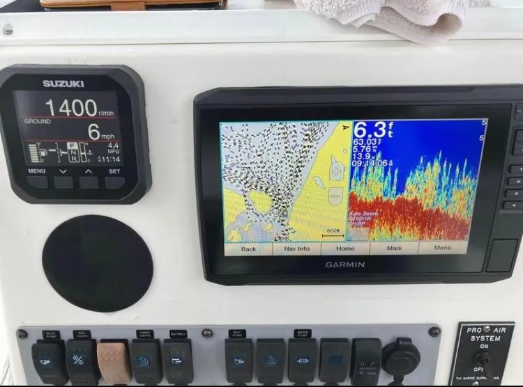 Slide: The Image of Boat dashboard with Suzuki and Garmin displays, Sea Born FX24 Bay, 2015 model. - 5