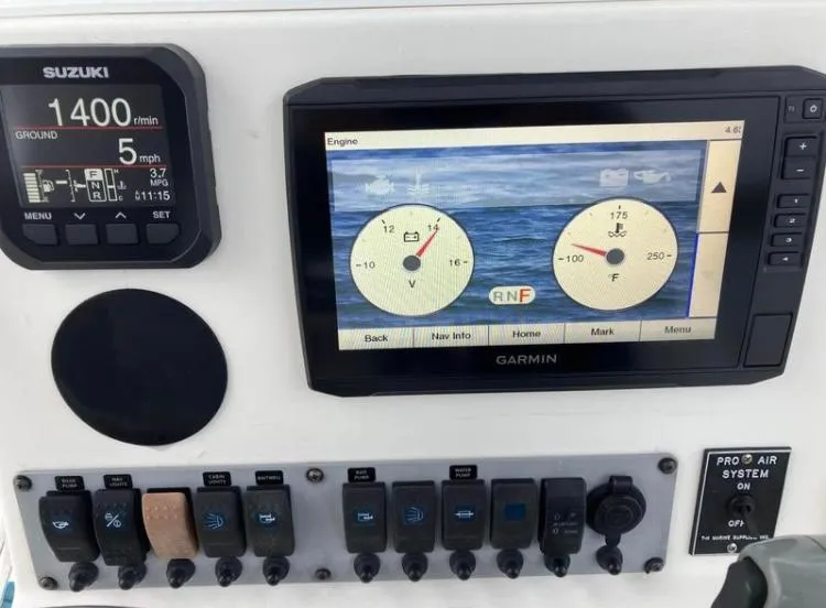 Slide: The Image of Dashboard of a 2015 Sea Born FX24 Bay boat with Suzuki and Garmin displays. - 6