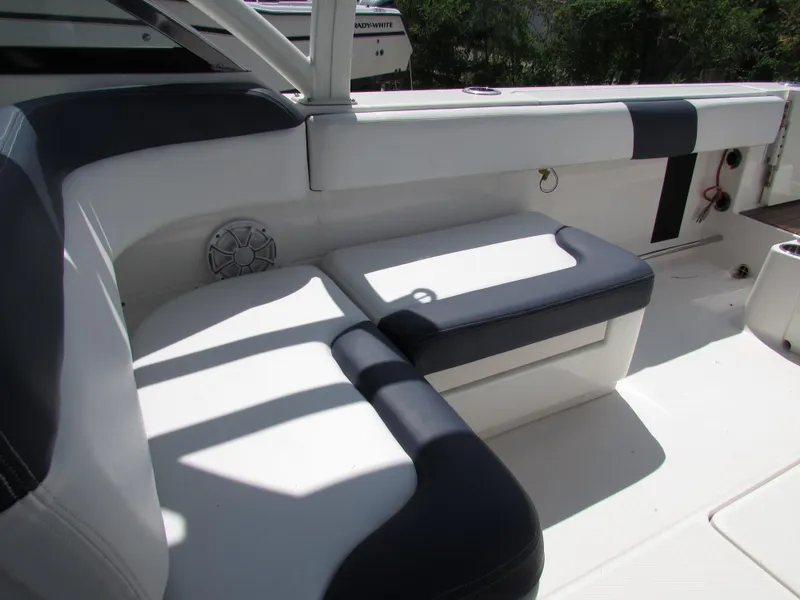 Slide: The Image of 2017 Robalo 317 boat interior with cushioned seating and speaker. - 11