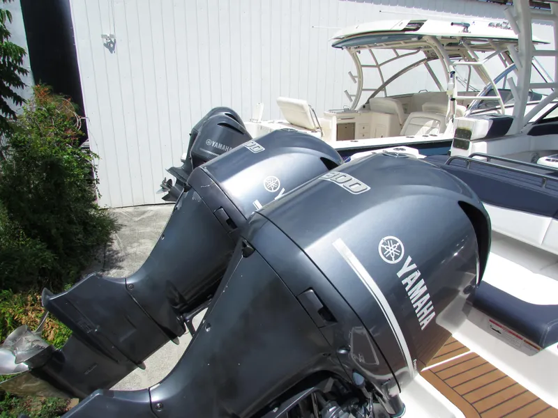 Slide: The Image of 2017 Robalo 317 boat with Yamaha outboard engines, docked near a white wall. - 3