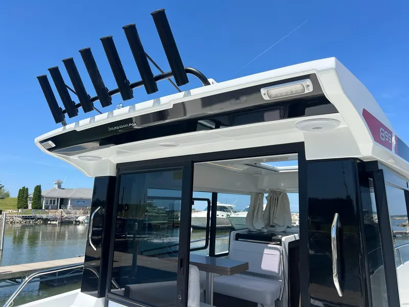Slide: The Image of 2025 Jeanneau NC 895 Sport S2 boat docked, featuring sleek design and spacious interior. - 11
