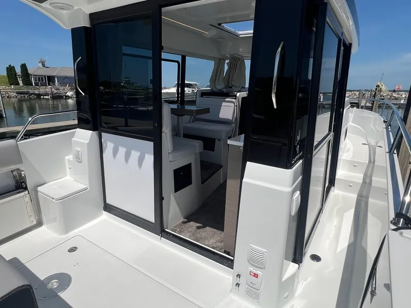 Slide: The Image of 2025 Jeanneau NC 895 Sport S2 boat interior with sleek design and spacious seating. - 12