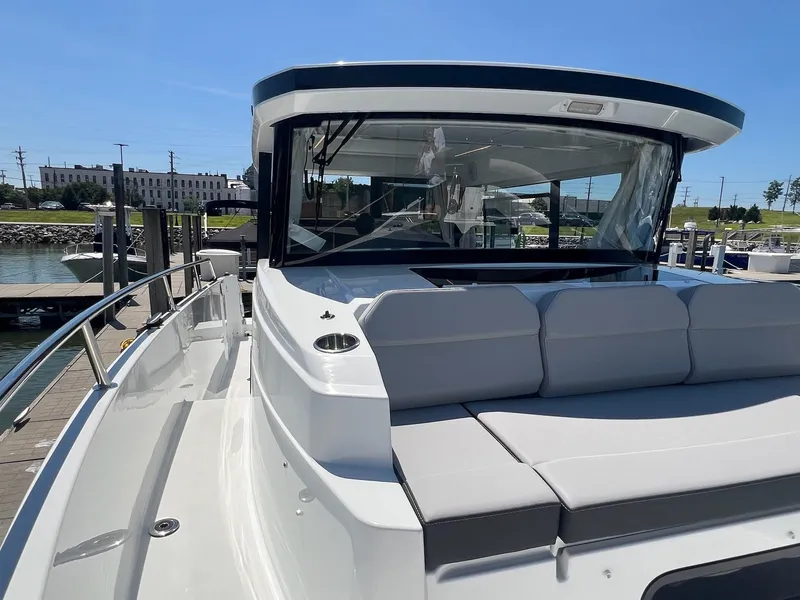 Slide: The Image of 2025 Jeanneau NC 895 Sport S2 boat with sleek design and spacious seating at dock. - 16