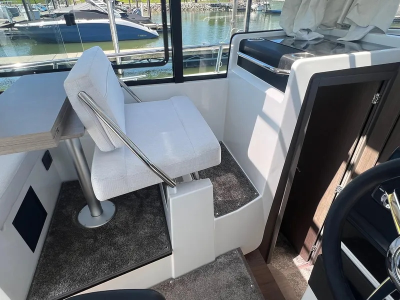 Slide: The Image of Interior of 2025 Jeanneau NC 895 Sport S2 boat with seating and table. - 22
