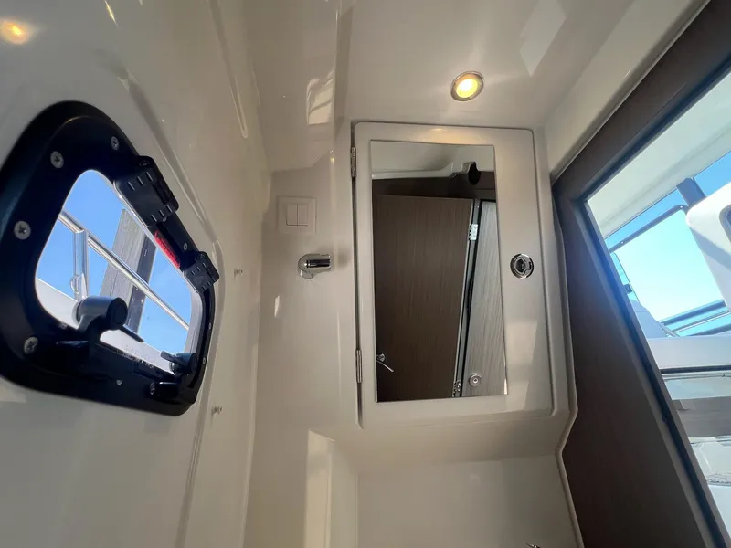 Slide: The Image of Interior of 2025 Jeanneau NC 895 Sport S2, featuring window and mirror. - 28