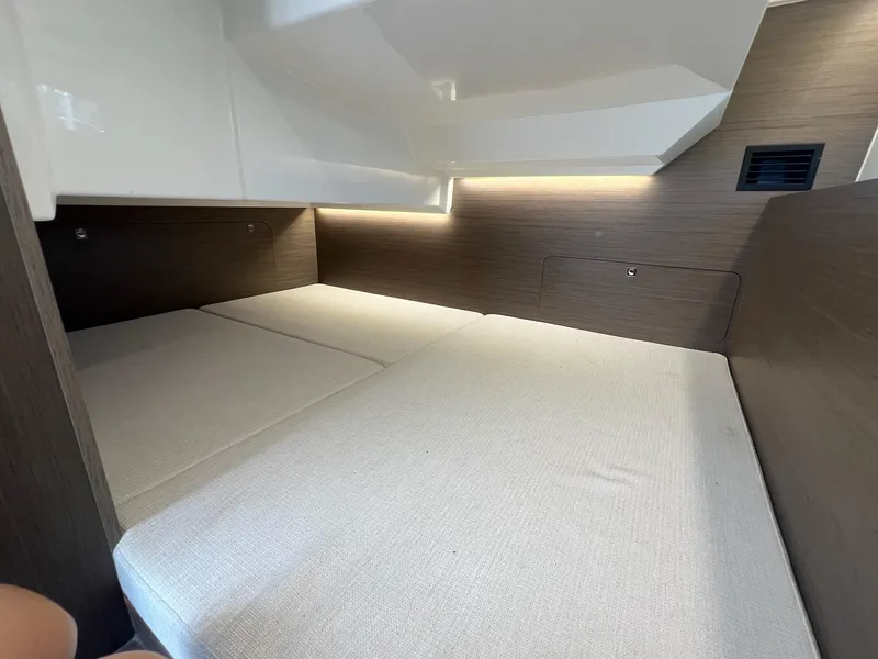 Slide: The Image of 2025 Jeanneau NC 895 Sport S2 cabin interior with modern design and cozy bedding. - 35