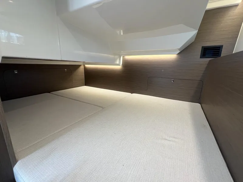 Slide: The Image of Interior cabin of 2025 Jeanneau NC 895 Sport S2, featuring modern design and cozy bedding. - 36