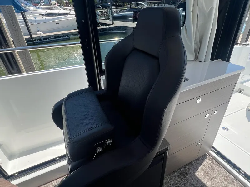 Slide: The Image of Captain's chair on 2025 Jeanneau NC 895 Sport S2 boat, docked at marina. - 39