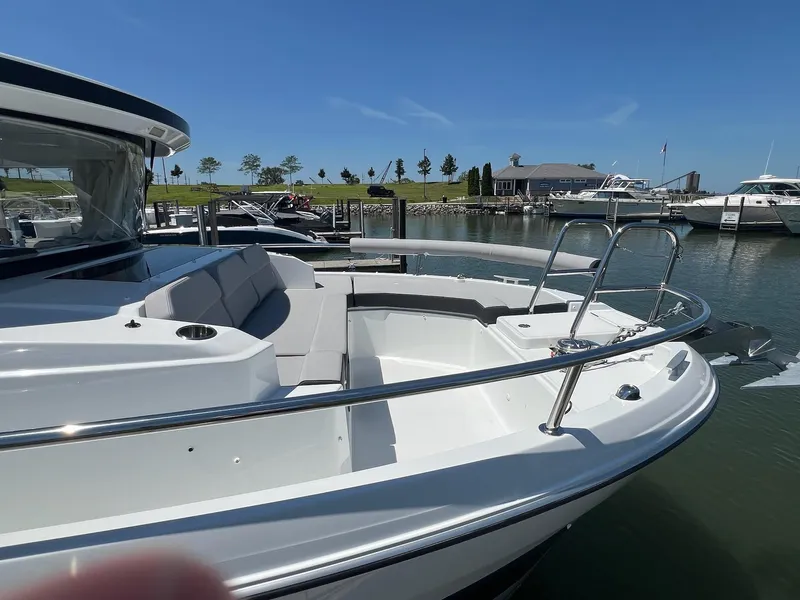 Slide: The Image of 2025 Jeanneau NC 895 Sport S2 boat docked, featuring sleek design and spacious seating. - 4