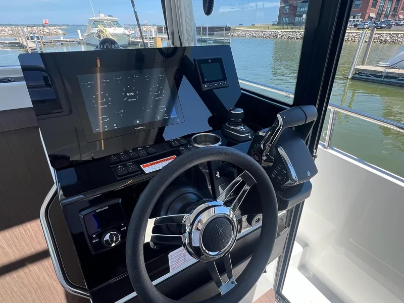 Slide: The Image of Helm of 2025 Jeanneau NC 895 Sport S2 with modern navigation controls. - 40