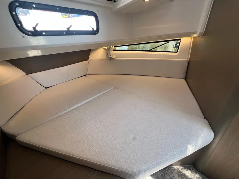 Slide: The Image of Interior cabin of 2025 Jeanneau NC 895 Sport S2, featuring cozy seating and window view. - 44