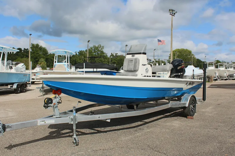 The Image of 2026 Avid 19 FSX boat on trailer, blue and white design, parked outdoors. - 32