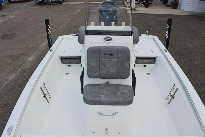 Slide: The Image of 2026 Avid 19 FSX boat interior with gray seating and console. - 51