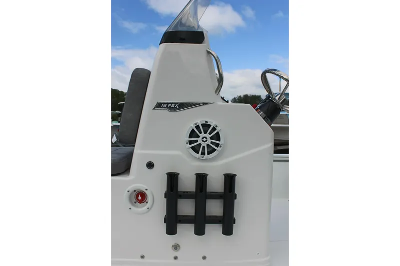 Slide: The Image of Avid 19 FSX 2026 boat console with rod holders and speaker. - 53