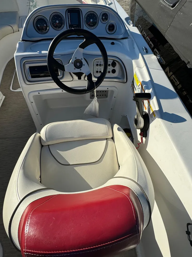 Slide: The Image of 2013 Hurricane SS 203 OB boat cockpit with steering wheel and control panel. - 12