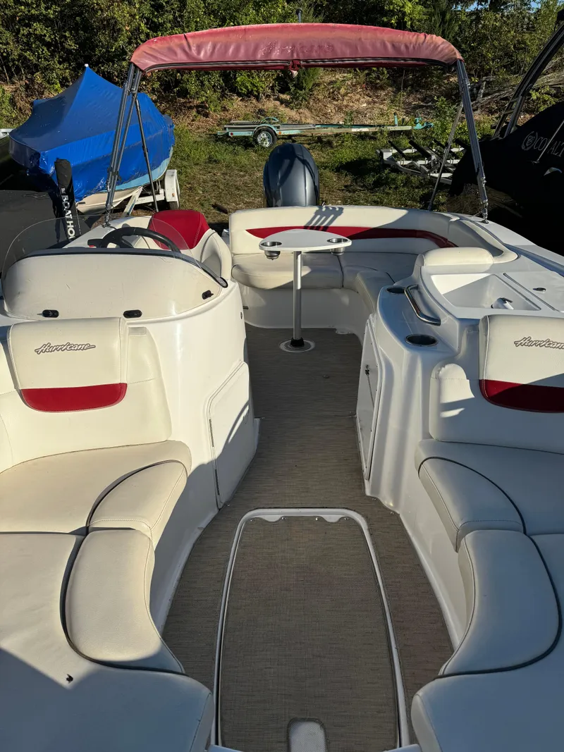 Slide: The Image of 2013 Hurricane SS 203 OB boat interior with red canopy and seating. - 3