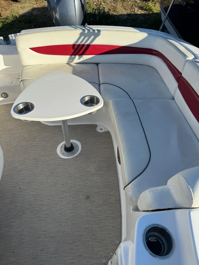 Slide: The Image of 2013 Hurricane SS 203 OB boat interior with white and red seating and table. - 8