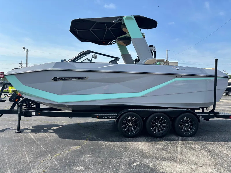 Slide: The Image of 2025 Nautique G23 boat on trailer, featuring sleek design and modern accents. - 10
