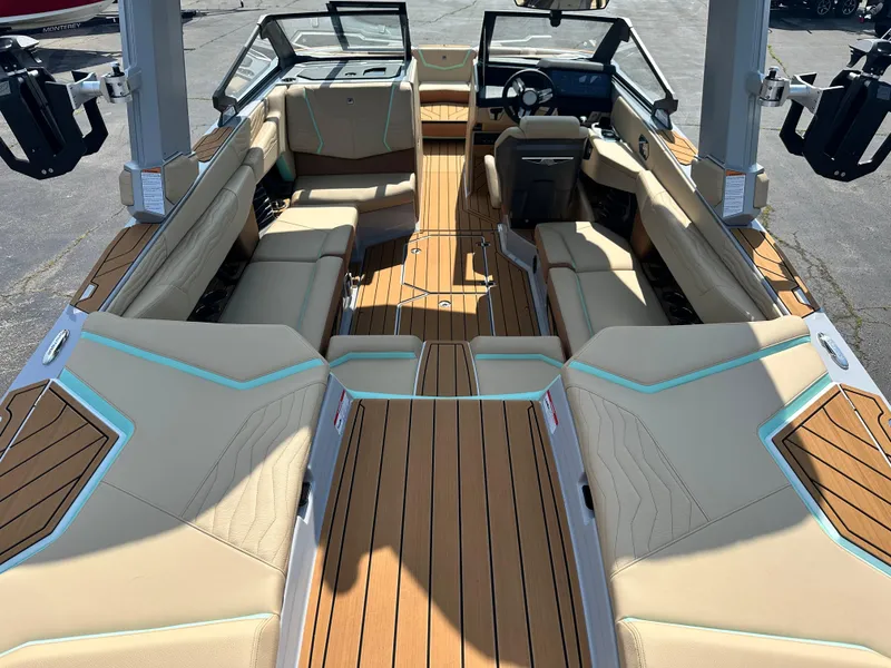 Slide: The Image of 2025 Nautique G23 boat interior with luxurious tan seating and sleek design. - 13