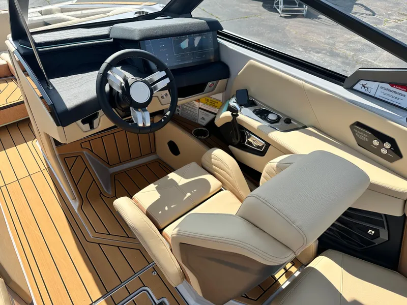 Slide: The Image of 2025 Nautique G23 boat interior with modern dashboard and luxurious seating. - 15