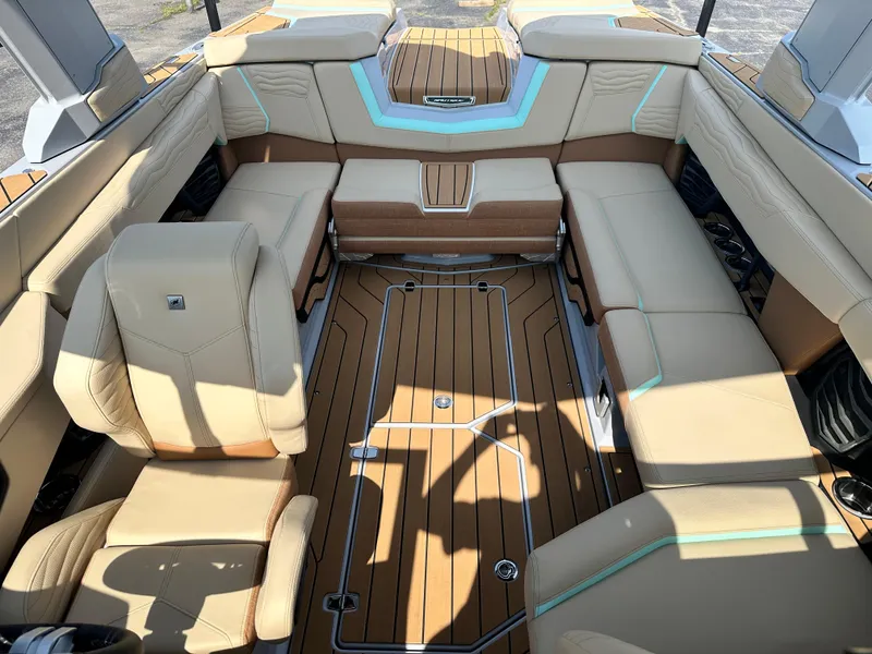 Slide: The Image of 2025 Nautique G23 boat interior with beige seating and teak flooring. - 20