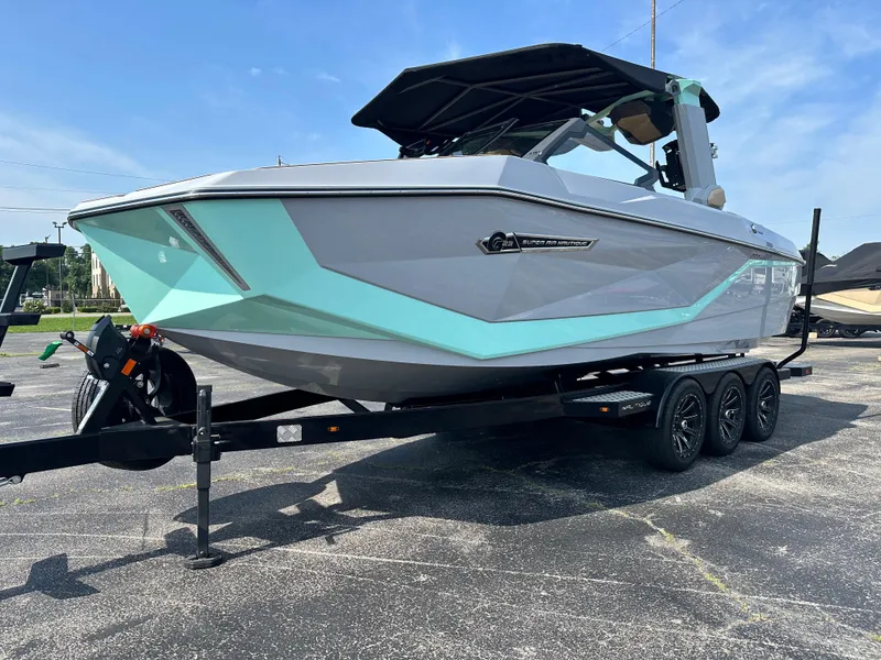 Slide: The Image of 2025 Nautique G23 boat on trailer, featuring sleek design and modern aesthetics. - 3