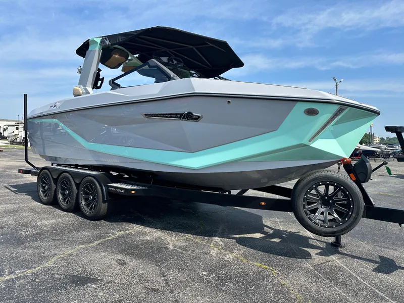 Slide: The Image of 2025 Nautique G23 boat on trailer, featuring sleek design and modern accents. - 6