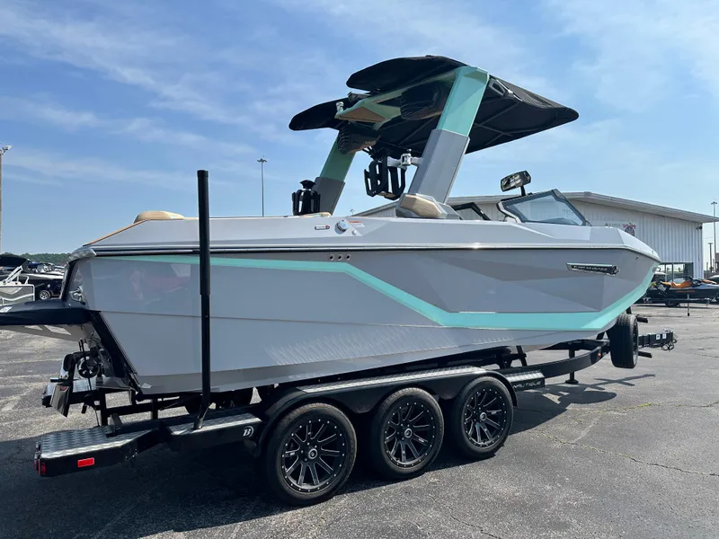 Slide: The Image of 2025 Nautique G23 boat on trailer, sleek design, parked outdoors. - 8
