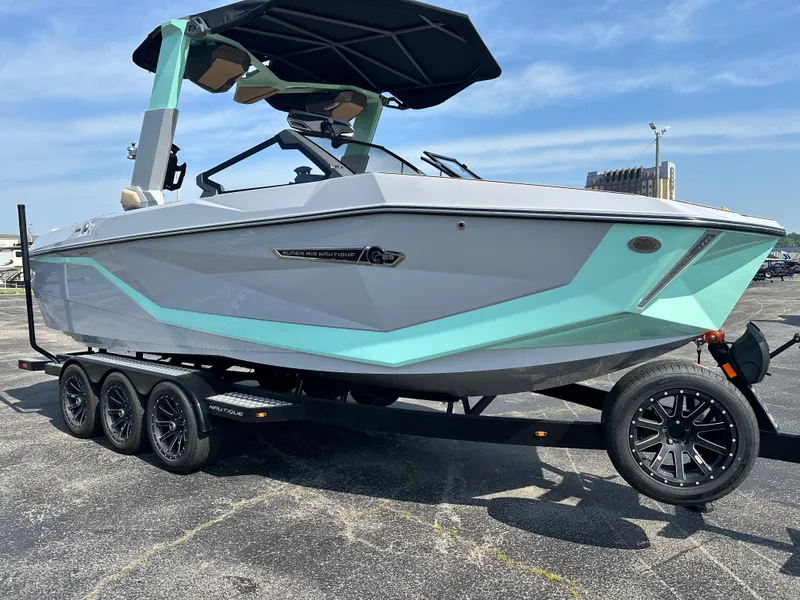 Slide: The Image of 2025 Nautique G23 boat on trailer, featuring sleek design and modern color accents. - 9