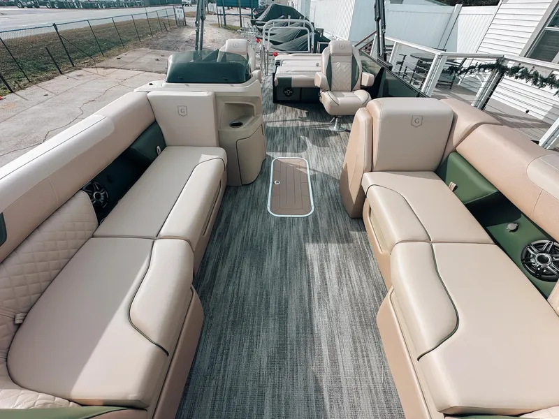 Slide: The Image of 2025 Godfrey SW 2286 SFL pontoon boat interior with beige seating and modern design. - 2