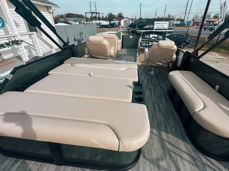 Slide: The Image of 2025 Godfrey SW 2286 SFL pontoon boat interior with beige seating and modern dashboard. - 6