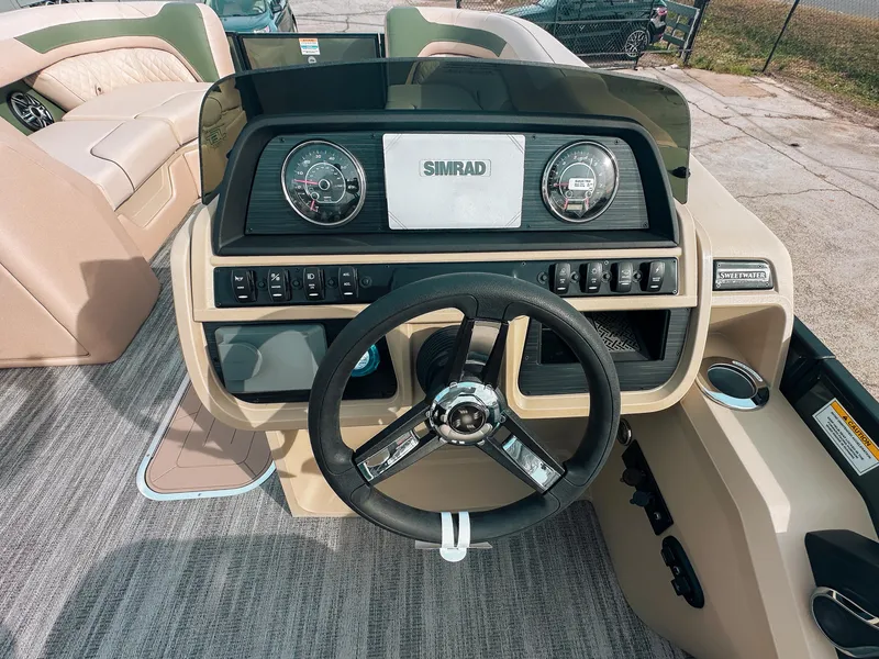 Slide: The Image of 2025 Godfrey SW 2286 SFL boat dashboard with steering wheel and control panel. - 9