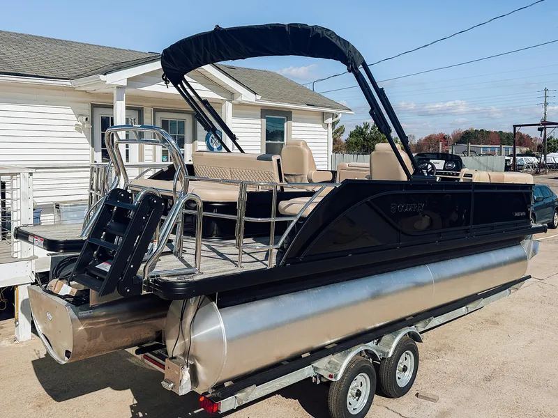 Slide: The Image of 2025 Godfrey Sweetwater 22' Flip Lounge Tritoon on trailer, featuring sleek design and spacious seating. - 15