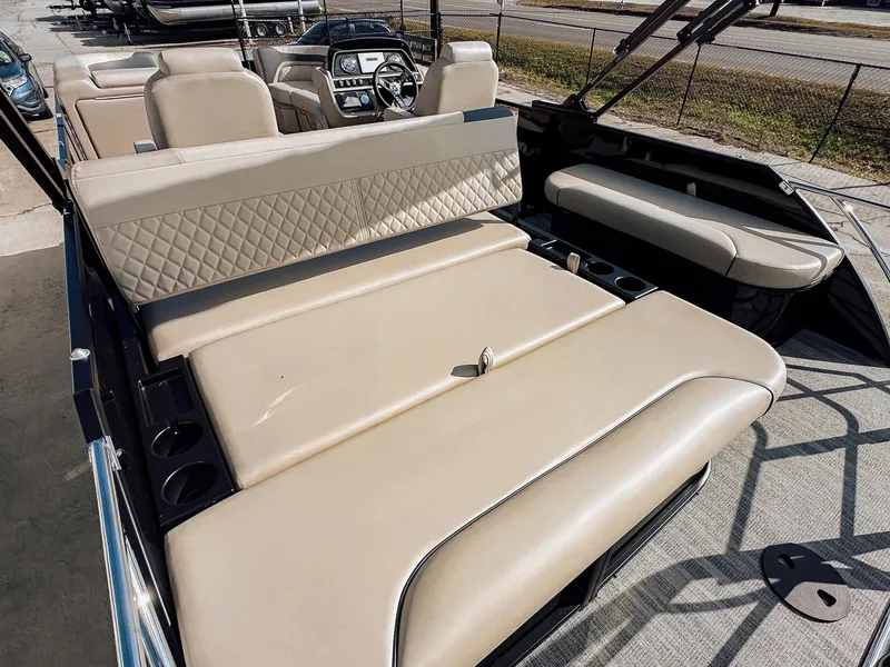 Slide: The Image of 2025 Godfrey Sweetwater 22' Flip Lounge Tritoon with beige seating and modern dashboard. - 19
