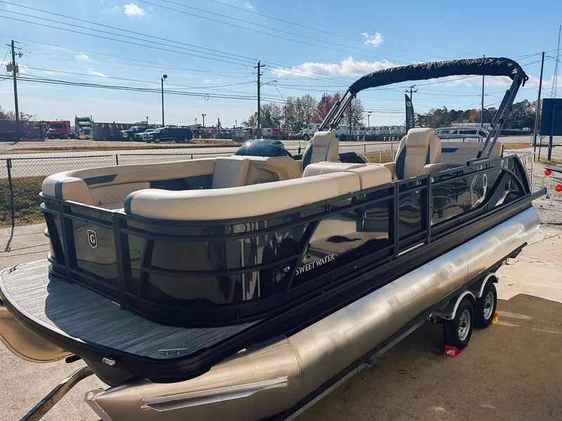 Slide: The Image of 2025 Godfrey Sweetwater 22' Flip Lounge Tritoon, sleek design, parked outdoors. - 26