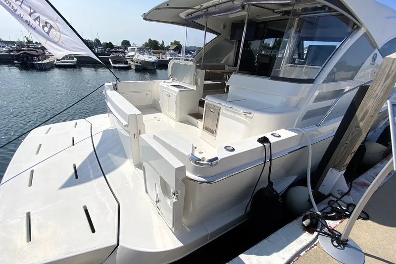 Slide: The Image of 2025 Riviera 465 SUV yacht docked at marina, showcasing spacious deck and modern design. - 10