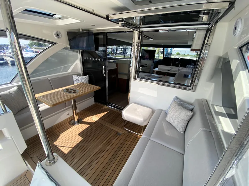Slide: The Image of Luxurious interior of 2025 Riviera 465 SUV yacht with elegant seating and wooden flooring. - 11