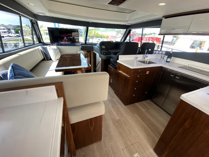 Slide: The Image of Luxurious interior of 2025 Riviera 465 SUV yacht with modern kitchen and seating area. - 12