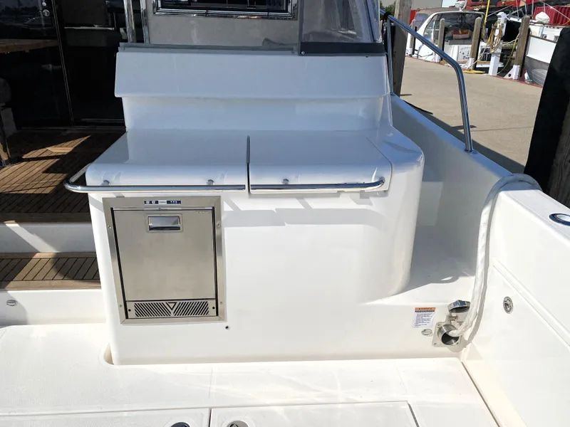 Slide: The Image of Riviera 465 SUV 2025 yacht deck with built-in storage and stainless steel appliance. - 15