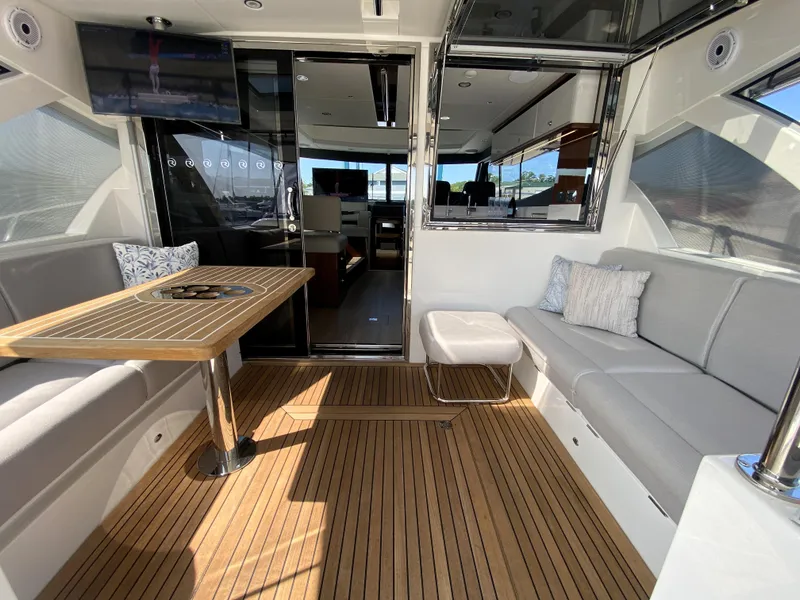 Slide: The Image of Luxurious 2025 Riviera 465 SUV yacht interior with elegant seating and wooden flooring. - 17