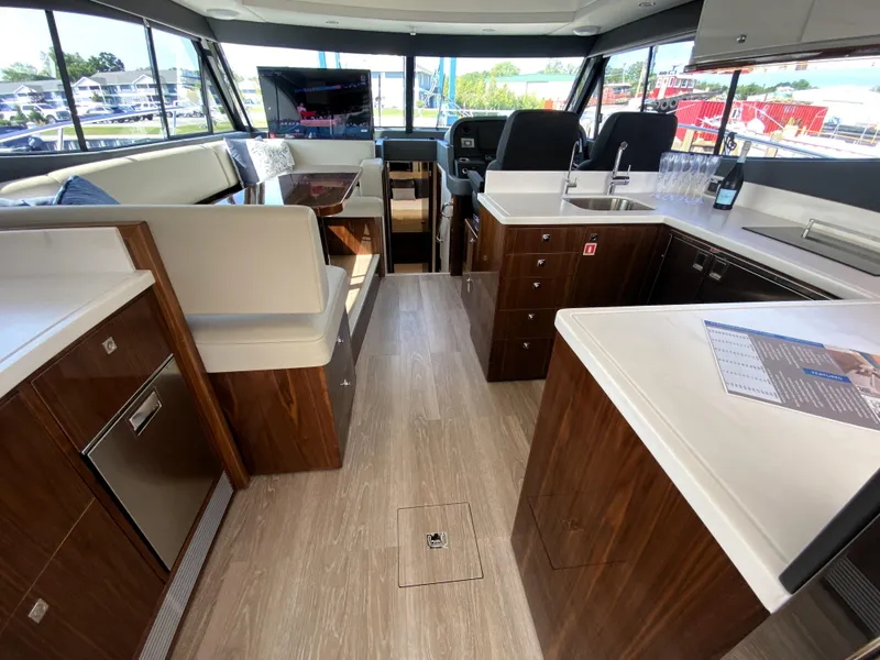 Slide: The Image of Luxurious interior of 2025 Riviera 465 SUV yacht with modern kitchen and seating area. - 19