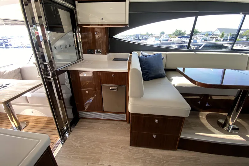 Slide: The Image of Luxurious interior of 2025 Riviera 465 SUV yacht with modern kitchen and seating area. - 20