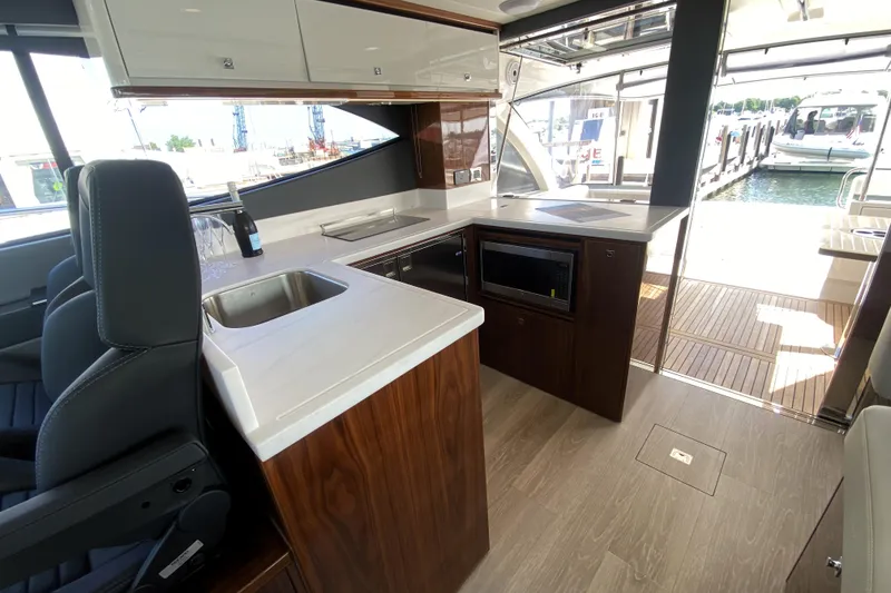 Slide: The Image of Luxurious interior of 2025 Riviera 465 SUV yacht with modern kitchen and sleek design. - 22