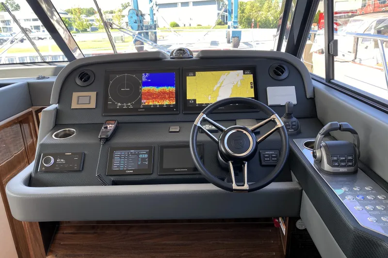 Slide: The Image of 2025 Riviera 465 SUV helm with advanced navigation and control systems. - 28