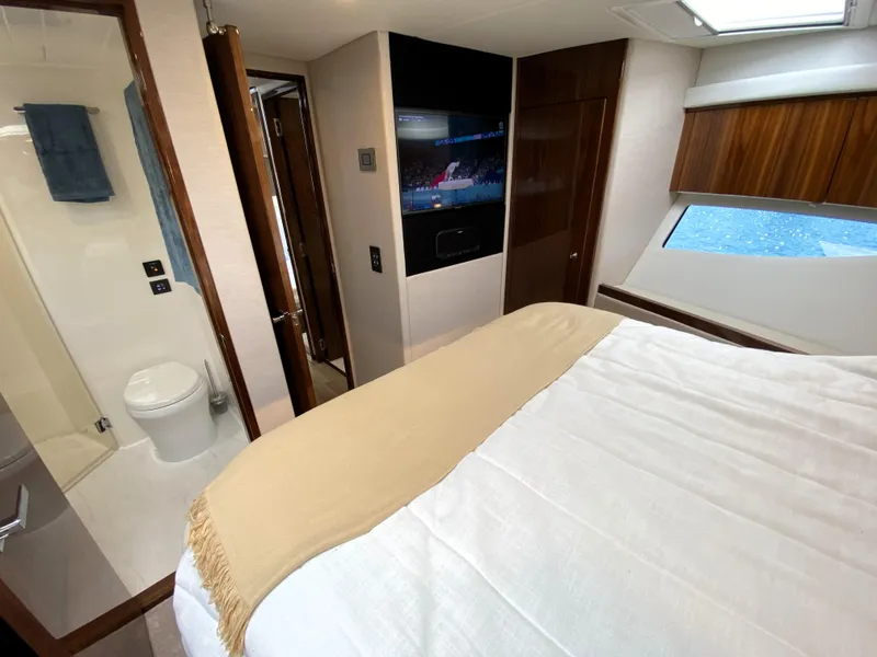 Slide: The Image of Luxurious bedroom interior of 2025 Riviera 465 SUV yacht with modern amenities. - 30