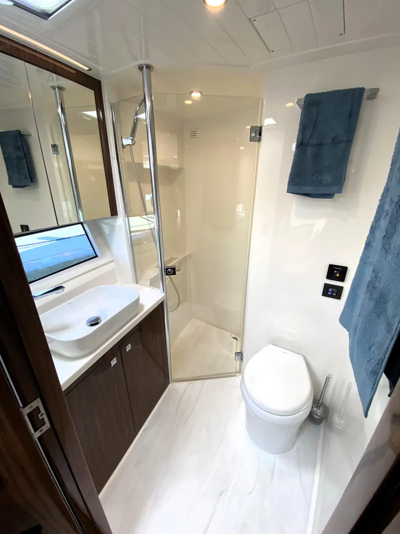 Slide: The Image of Luxurious bathroom in 2025 Riviera 465 SUV yacht with modern fixtures and elegant design. - 31