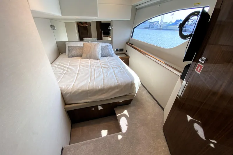 Slide: The Image of Luxurious bedroom interior of 2025 Riviera 465 SUV yacht with waterfront view. - 32