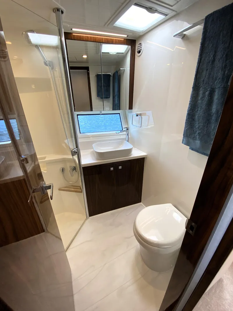 Slide: The Image of Modern bathroom in 2025 Riviera 465 SUV yacht with sleek design and ocean view. - 34