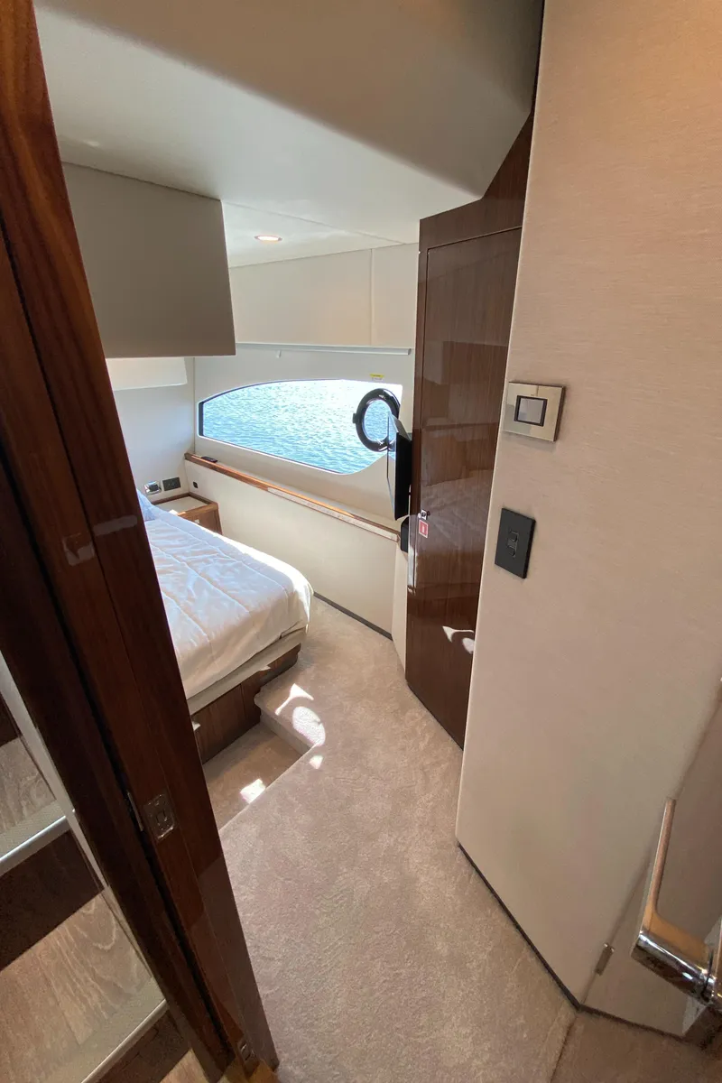 Slide: The Image of Interior of 2025 Riviera 465 SUV yacht, featuring a cozy bedroom with modern design. - 35