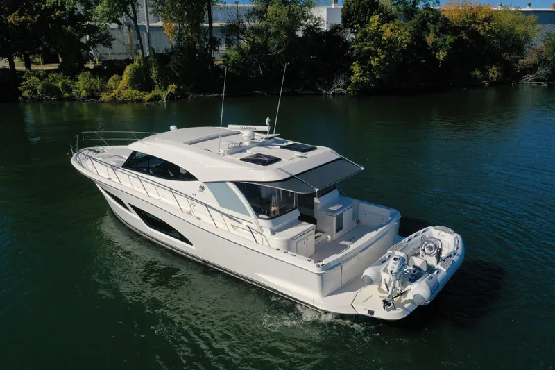 Slide: The Image of 2025 Riviera 465 SUV luxury yacht cruising on a serene river. - 7